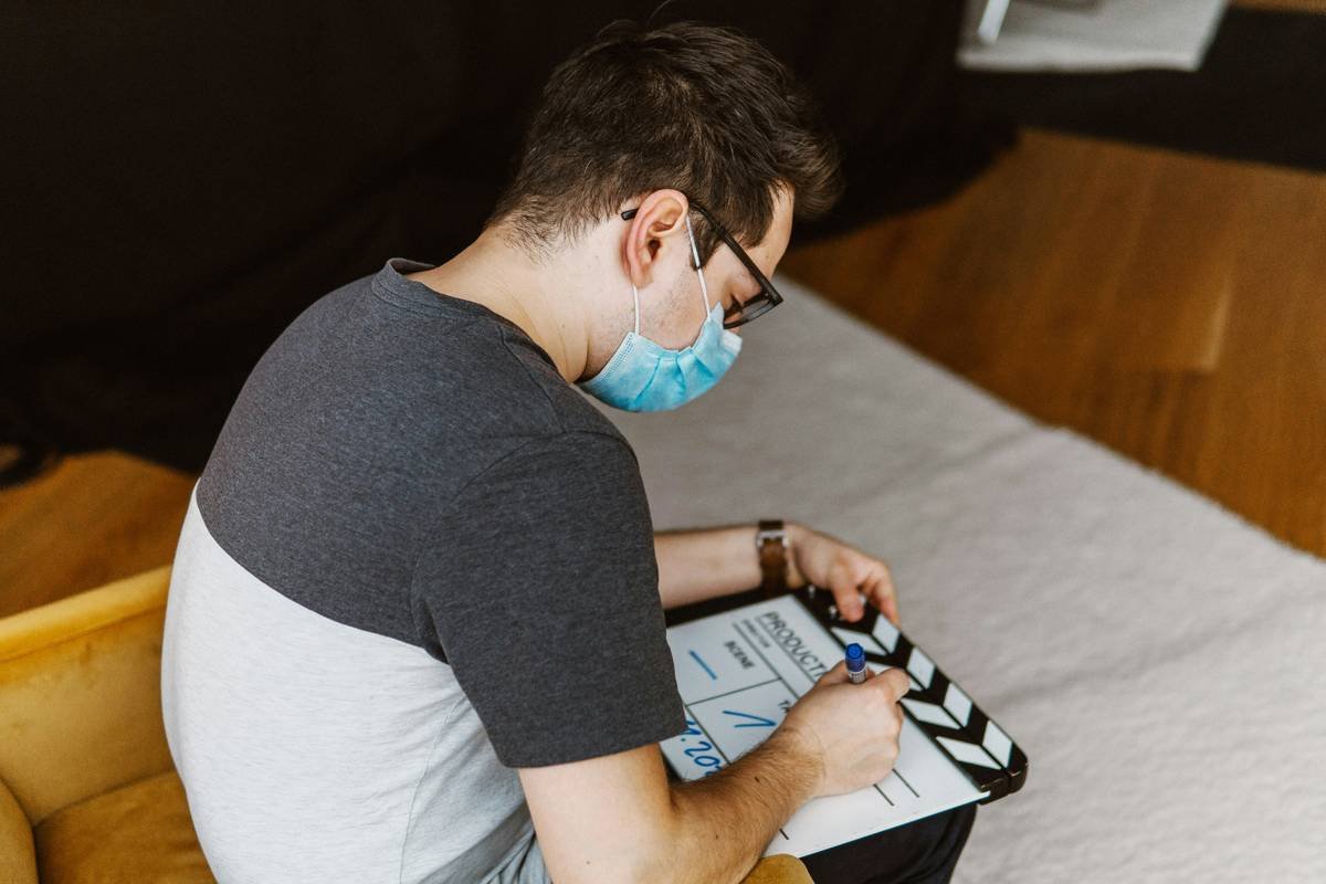 Camera assistant writing on a film slate.